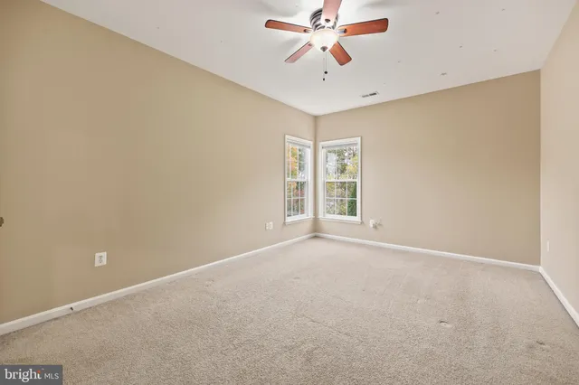 a spacious bathroom with a granite countertop sink mirror and a bathtub