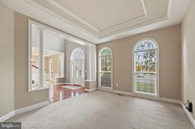 a kitchen with granite countertop white cabinets and wooden floor