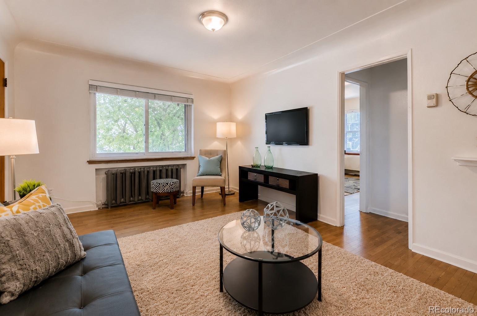 2050 Perry Street Denver, CO 80212 - Photo 2 of 15 a living room with furniture and a fireplace