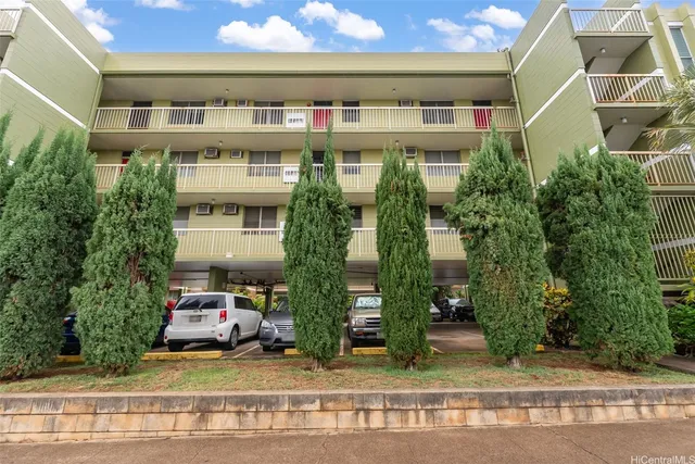 a front view of a building with garden