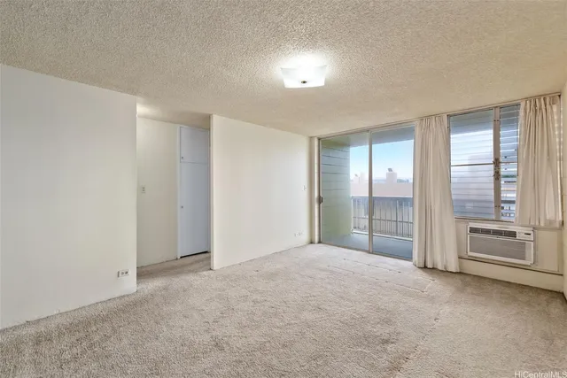 a view of an empty room with a kitchen