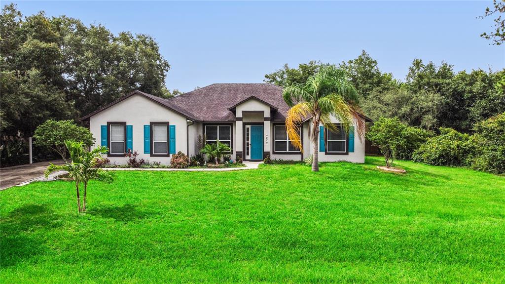 4879 Chisholm Park Trail St. Cloud, FL 34771 - Photo 1 of 1 a front view of a house with a yard and green space