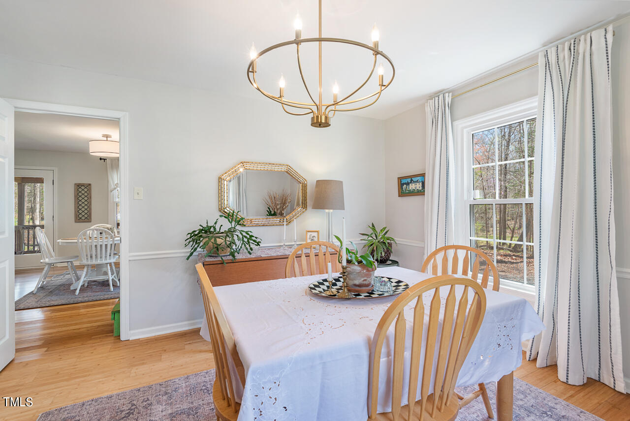 6014 Burgundy Road Durham, NC 27712 - Photo 11 of 46 a view of a dining room with furniture a potted plant and wooden floor