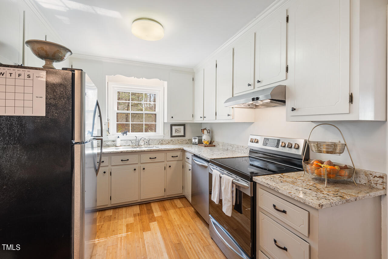 6014 Burgundy Road Durham, NC 27712 - Photo 22 of 46 a kitchen with a sink stove and cabinets
