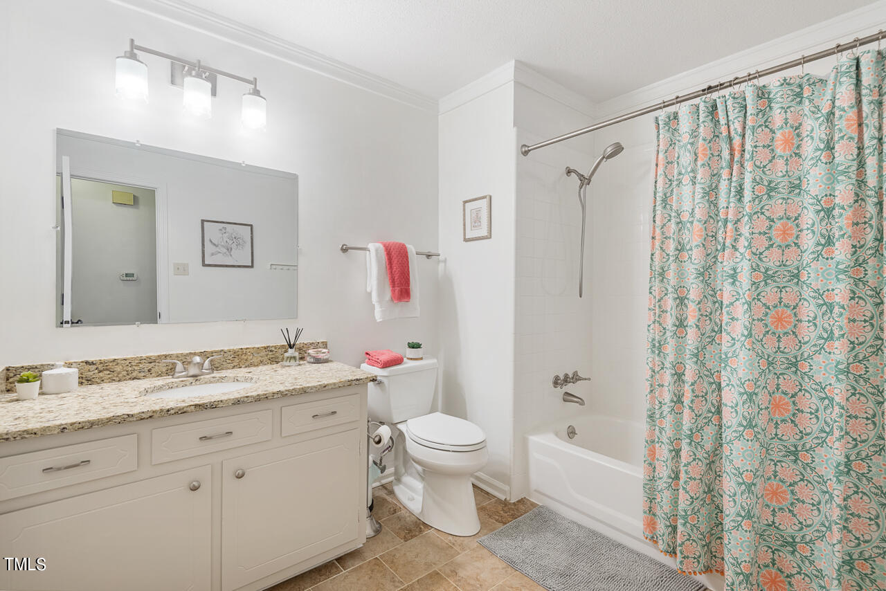 6014 Burgundy Road Durham, NC 27712 - Photo 35 of 46 a bathroom with a granite countertop sink toilet and shower