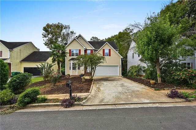 a front view of a house with garden