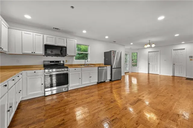 a large kitchen with cabinets and stainless steel appliances