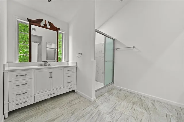 a view of a double vanity sink and a mirror in closet