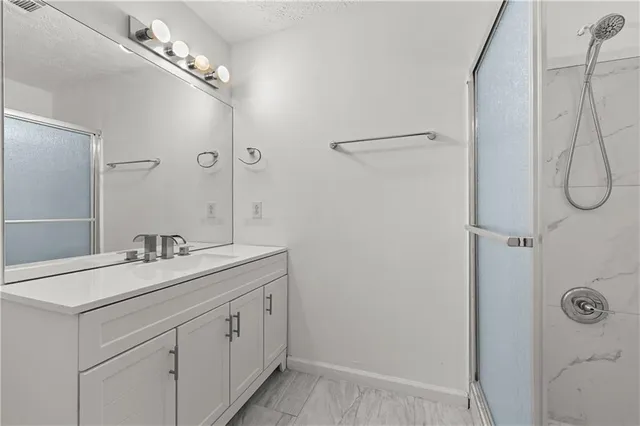 a view of a big room with windows and chandelier fan