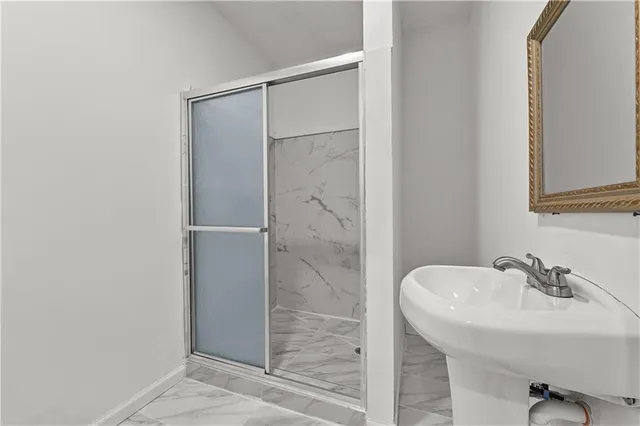 a view of a bedroom with wooden floor and a chandelier