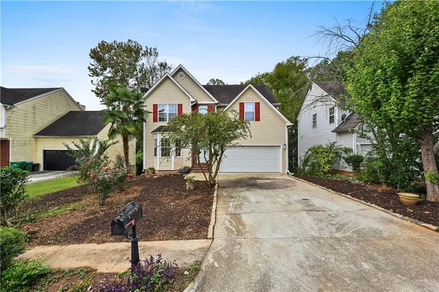 a front view of a house with garden