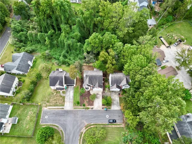 an aerial view of residential houses with outdoor space