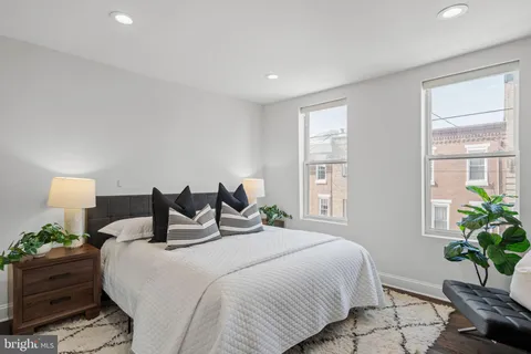a bedroom with bed and a potted plant
