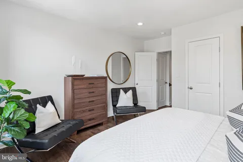 a bedroom with a bed and a potted plant