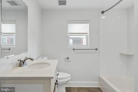 a bathroom with a sink toilet and tub