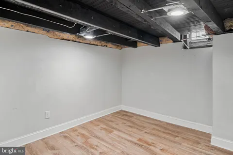 a view of a room with wooden floor