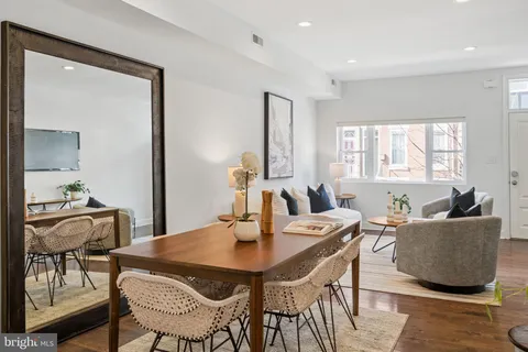 a dining room with furniture and window