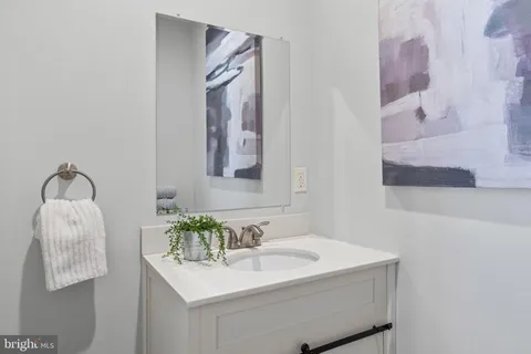 a bathroom with a sink vanity and mirror