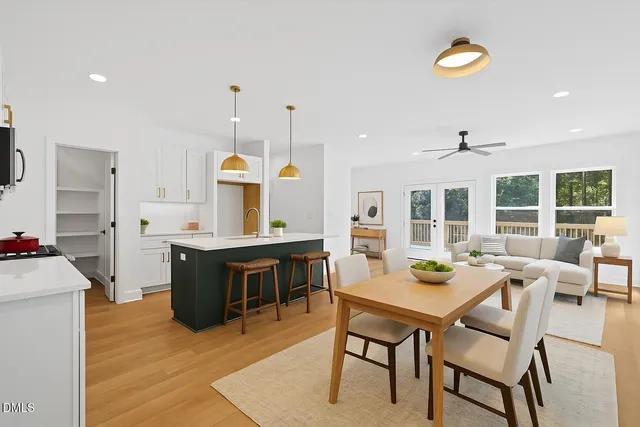 a living room with furniture a dining table and kitchen view