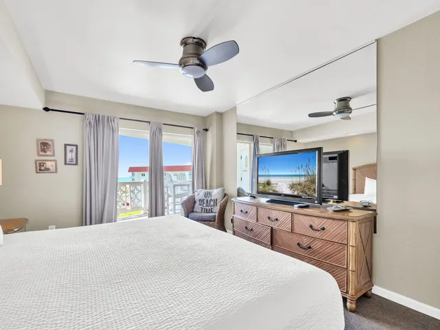 a bed room with a bed a television and a dresser