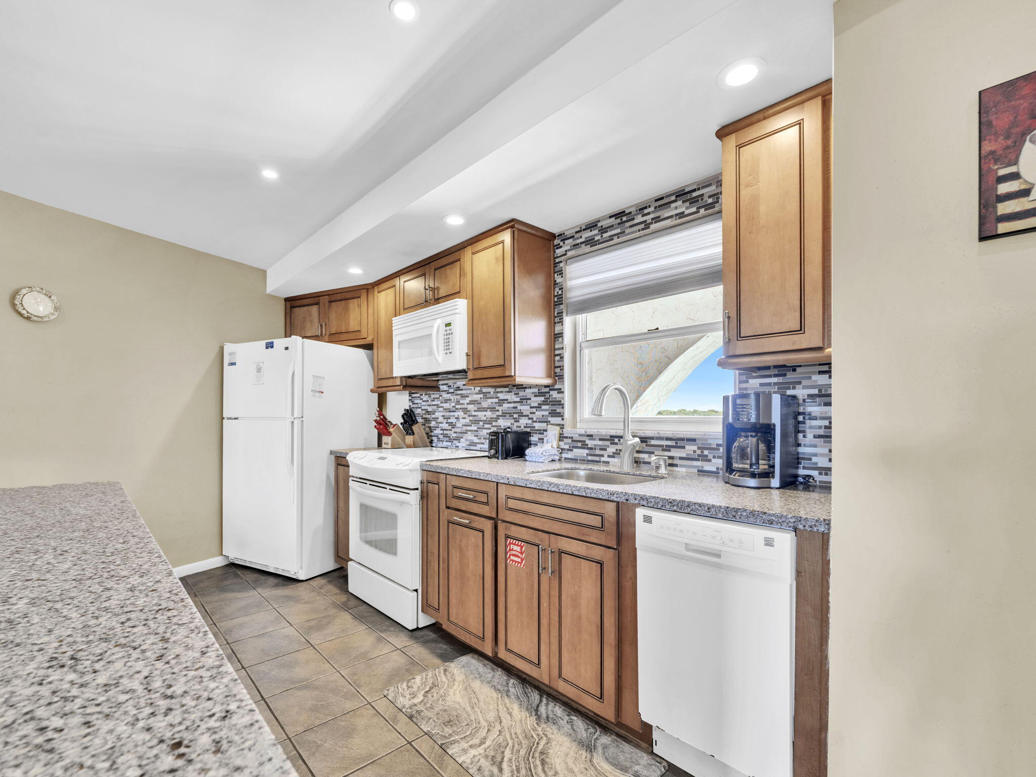 909 Santa Rosa Boulevard, Unit 165 Fort Walton Beach, FL 32548 - Photo 4 of 25 a kitchen with a sink stove and refrigerator