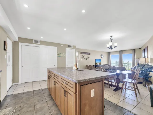 a kitchen with center island table and chairs in it