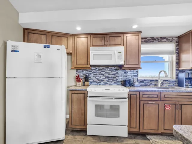 a white refrigerator freezer sitting inside of a kitchen