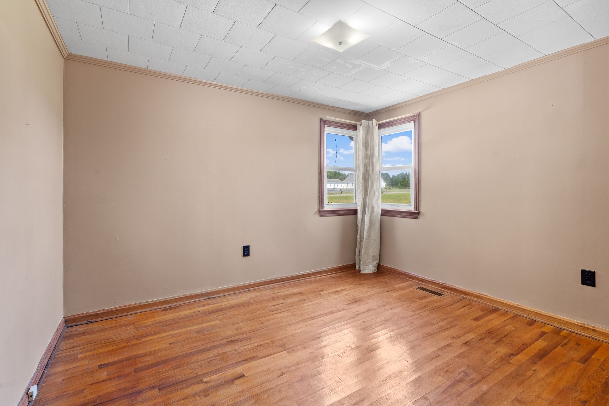 5295 Marion Road Cunningham, TN 37052 - Photo 22 of 33 an empty room with wooden floor and windows