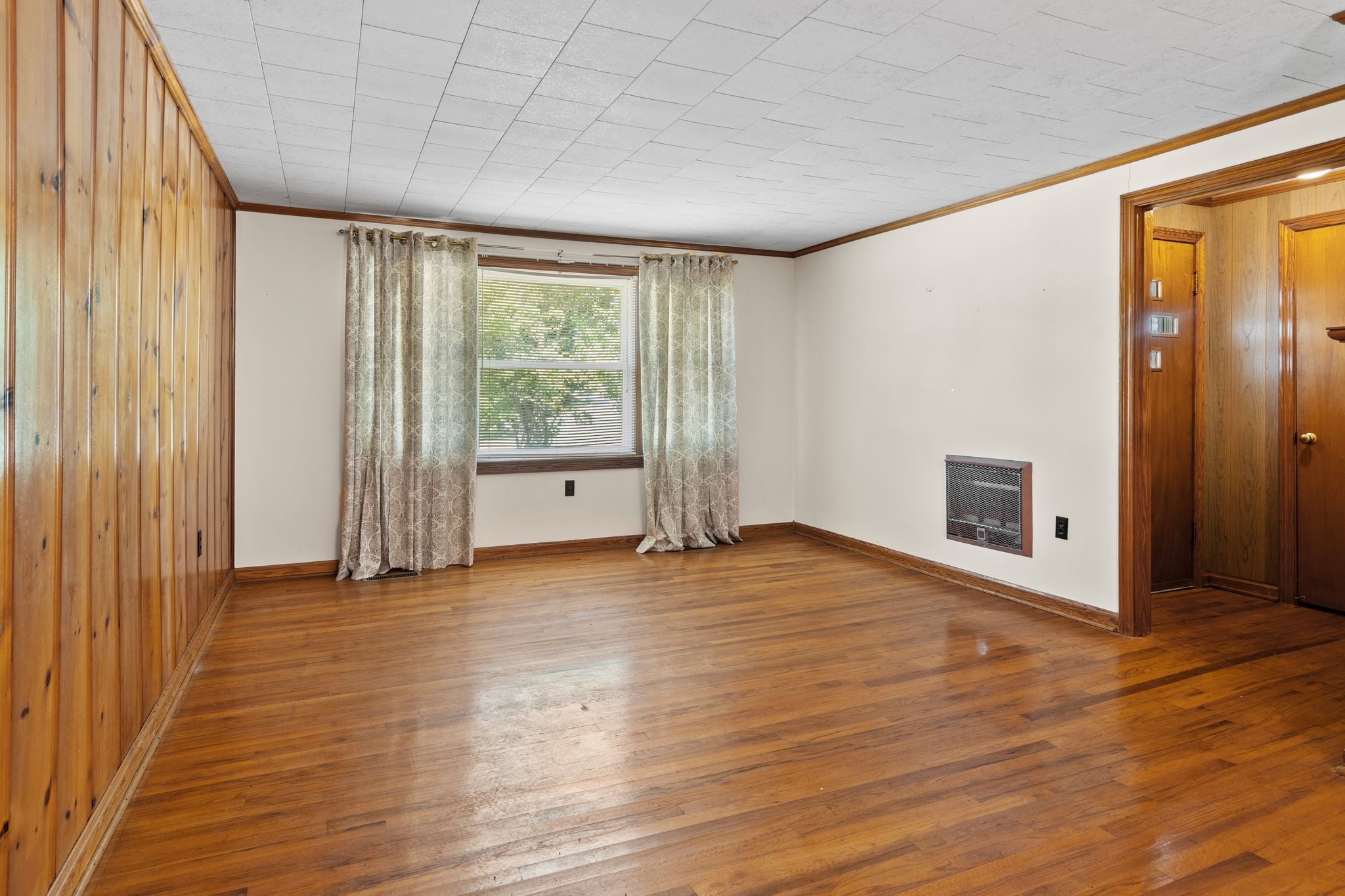 5295 Marion Road Cunningham, TN 37052 - Photo 10 of 33 a view of an empty room with wooden floor and a window