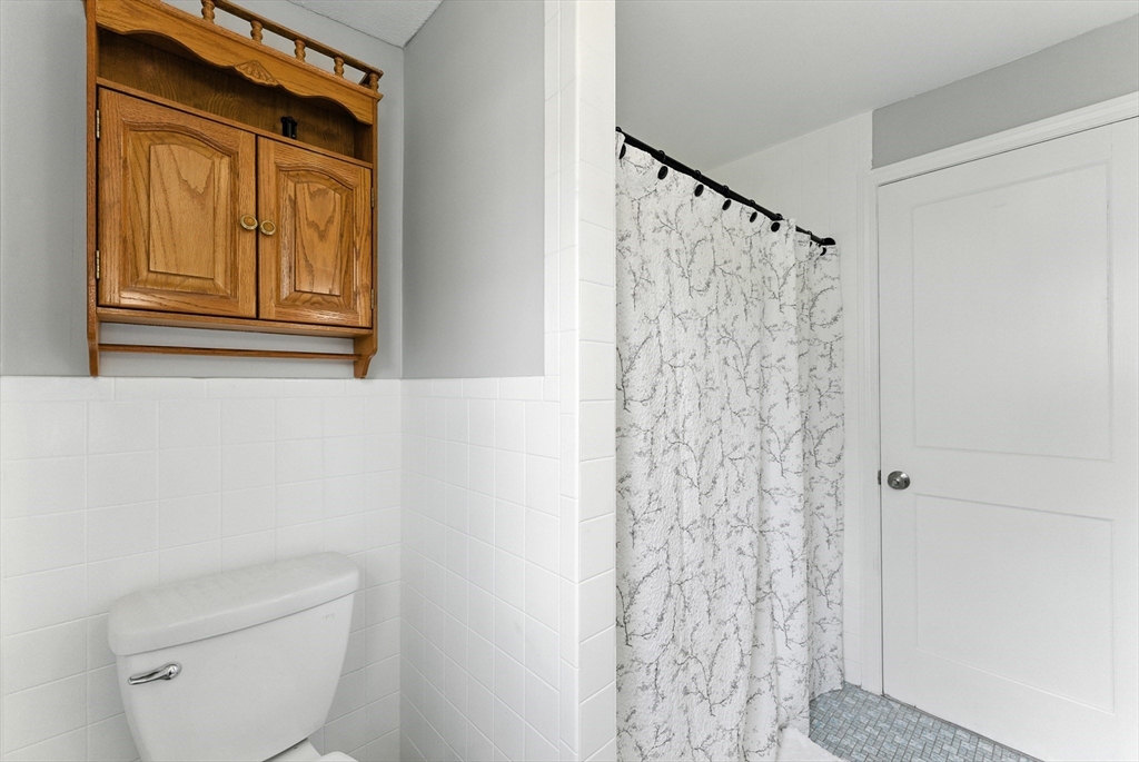 31 Fox Street West Springfield, MA 01089 - Photo 15 of 41 a bathroom with a shower curtain and a toilet