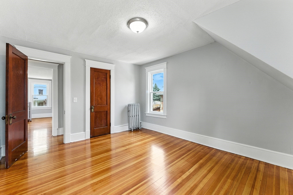 31 Fox Street West Springfield, MA 01089 - Photo 21 of 41 an empty room with wooden floor and windows
