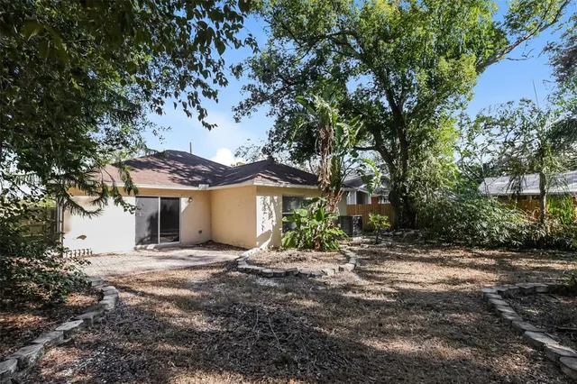 a view of a house with a tree in the yard