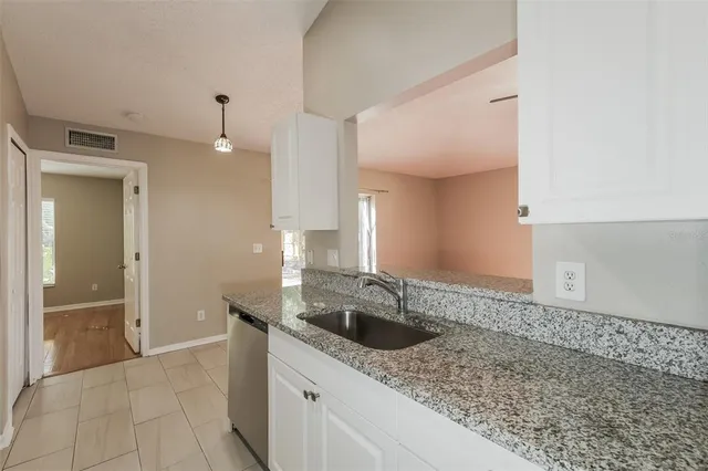 a kitchen with a sink a stove and cabinets
