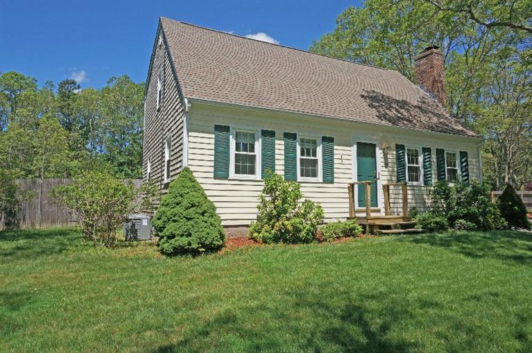 108 Old Mill Road Marstons Mills, MA 02648 - Photo 1 of 35 a view of a house with brick walls and a yard with plants
