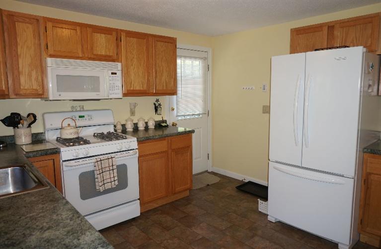 108 Old Mill Road Marstons Mills, MA 02648 - Photo 11 of 35 a kitchen with stainless steel appliances granite countertop white refrigerator stove a sink and dishwasher with wooden floor
