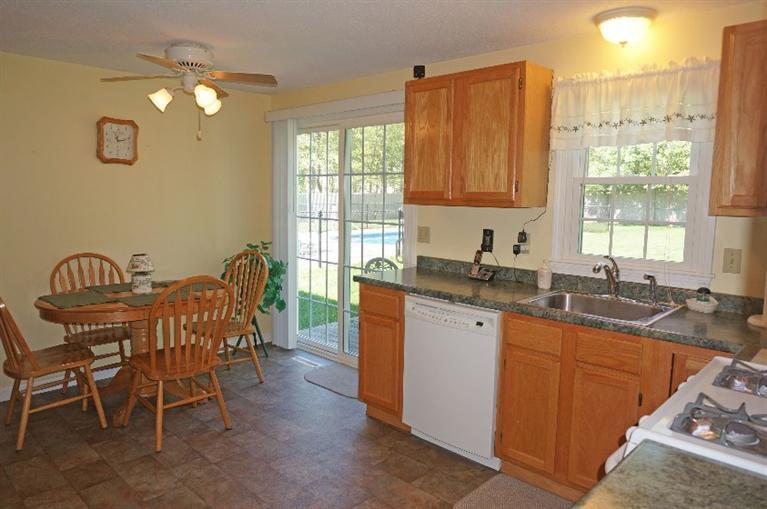 108 Old Mill Road Marstons Mills, MA 02648 - Photo 12 of 35 a kitchen with a table chairs sink and cabinets