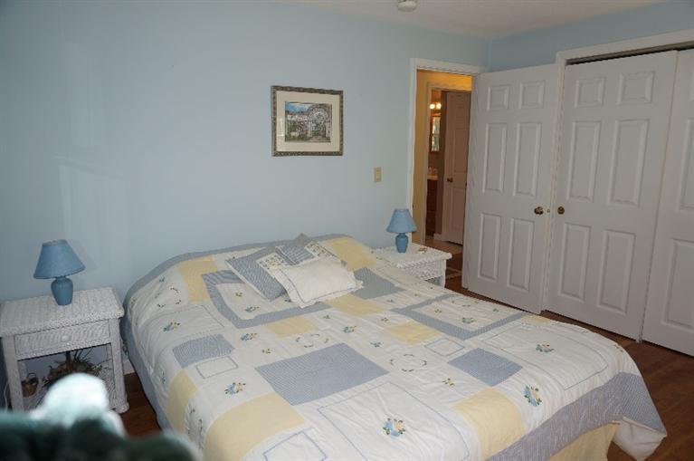 108 Old Mill Road Marstons Mills, MA 02648 - Photo 19 of 35 a bed sitting in a bedroom next to a cabinet