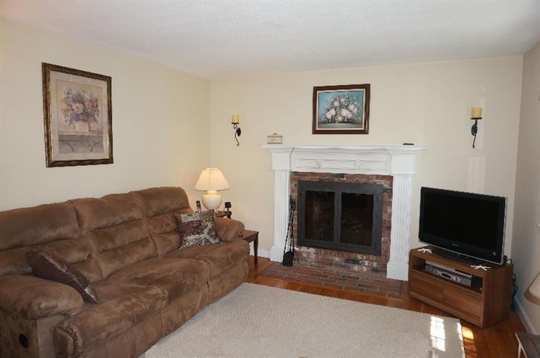 108 Old Mill Road Marstons Mills, MA 02648 - Photo 8 of 35 a living room with furniture a flat screen tv and a fireplace