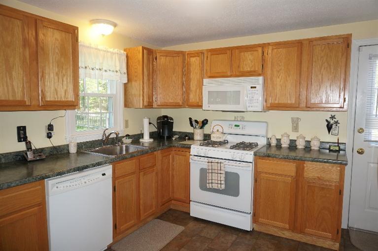 108 Old Mill Road Marstons Mills, MA 02648 - Photo 10 of 35 a kitchen with granite countertop cabinets stainless steel appliances a sink and a window