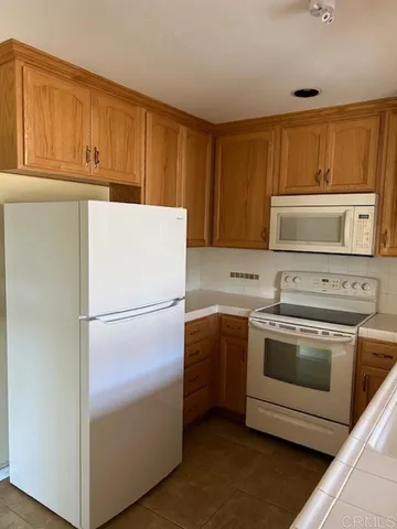 a white refrigerator freezer sitting in a kitchen