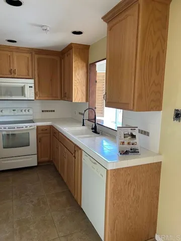 a kitchen with a sink stove and cabinets