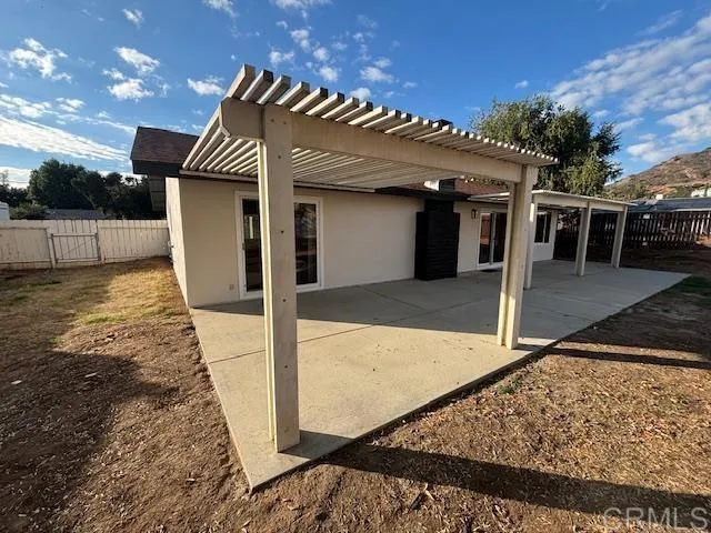 a view of a house with a wooden fence