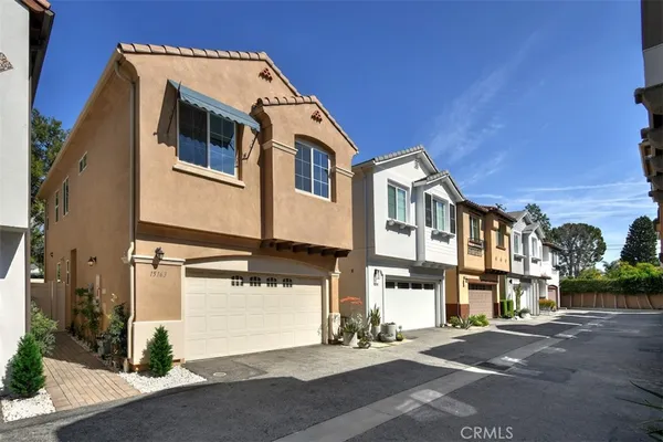a front view of a residential apartment building with a yard