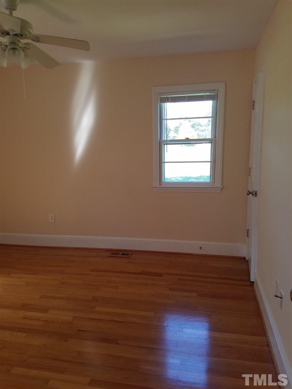 10328 Pasture Road Middlesex, NC 27557 - Photo 14 of 23 a view of an empty room with wooden floor and a window