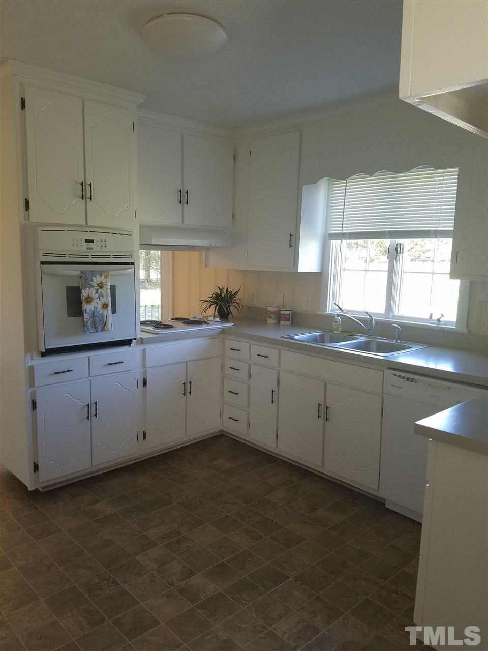 10328 Pasture Road Middlesex, NC 27557 - Photo 7 of 23 a kitchen with a sink stove and cabinets