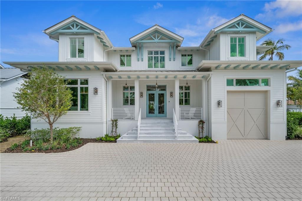 187 10th Avenue South Naples, FL 34102 - Photo 2 of 48 a front view of a house with garden