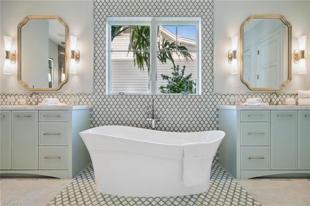 187 10th Avenue South Naples, FL 34102 - Photo 25 of 48 a bathroom with a sink a toilet and mirror