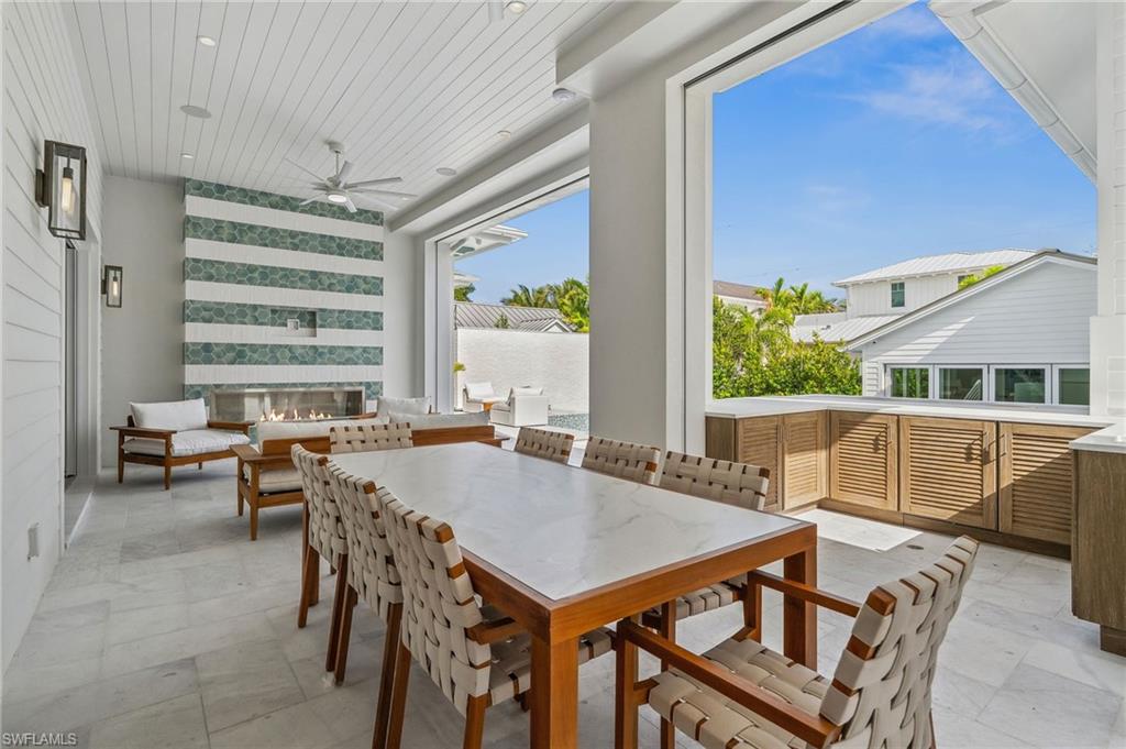 187 10th Avenue South Naples, FL 34102 - Photo 26 of 48 a view of a dining room with furniture window and outside view