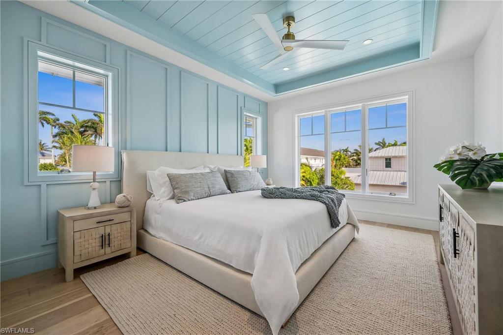 187 10th Avenue South Naples, FL 34102 - Photo 33 of 48 a bedroom with a bed and a painting on the wall