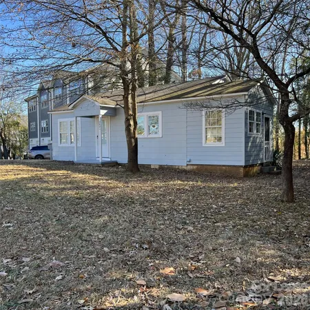 a house that has a tree in front of it